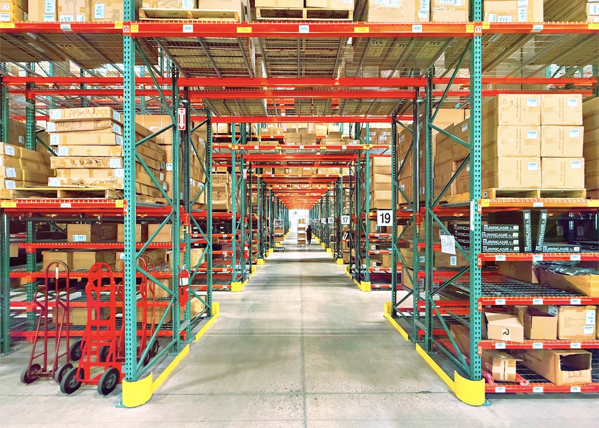 Warehouse aisles with tall shelving and picking bins